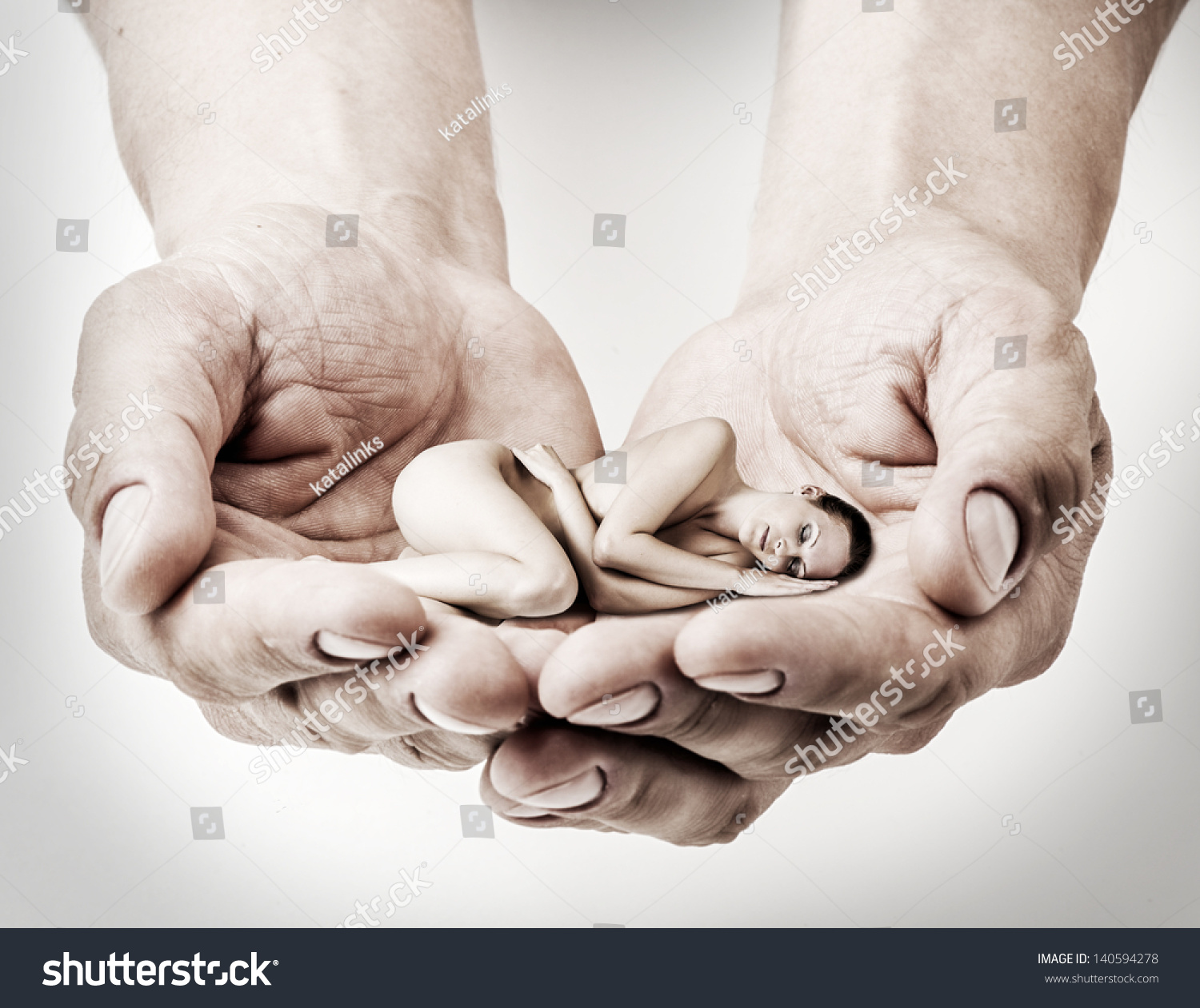 stock-photo-little-woman-is-sleeping-in-the-men-s-hands-loving-couple-140594278.jpg