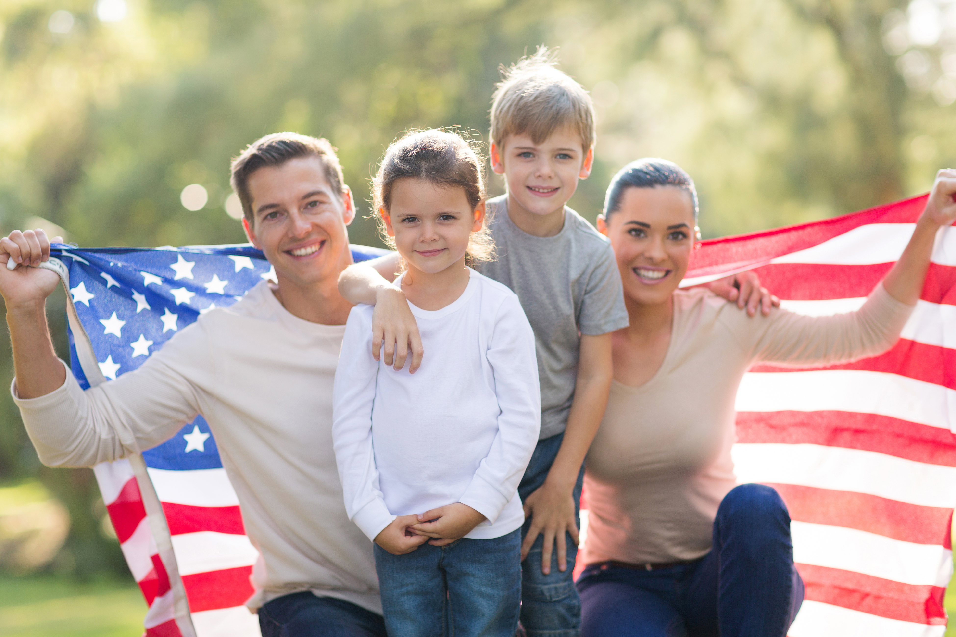 family-of-four-holding-an-american-flag.jpg